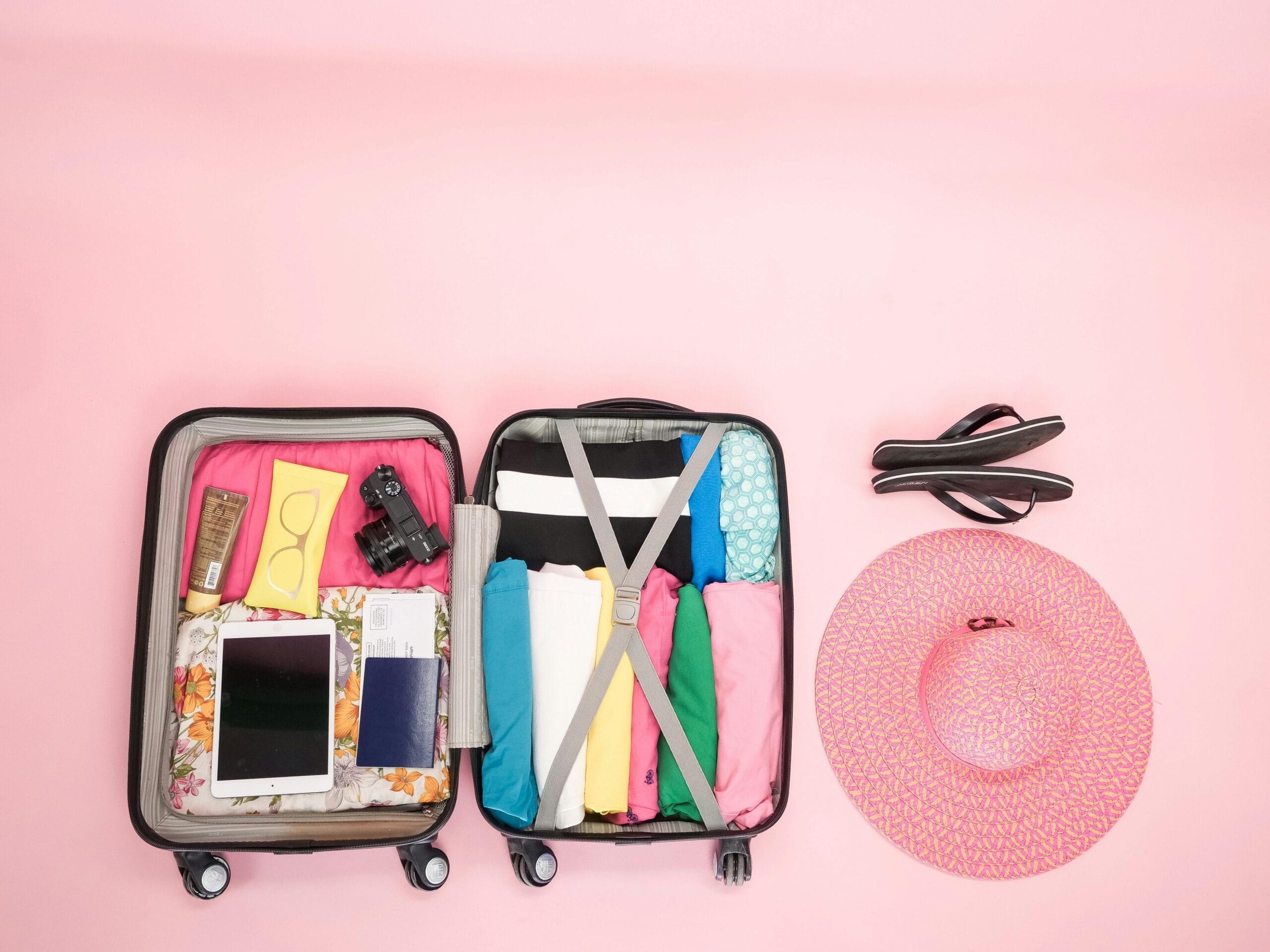 Suitcase with clothes Open suitcase packed neatly with clothes and travel essentials, perfect for a summer getaway.